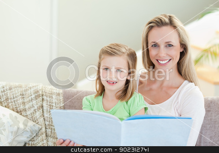 To use this stock image in your creative project, please select the size you need over to the right and click the "Add to Cart" button.
Your downloaded image will come with the Cutcaster watermark removed so don’t worry about the watermark you see on this page. Mother and daughter reading a magazine on the sofa stock photo, Mother and daughter reading a magazine together on the sofa by Wavebreak Media