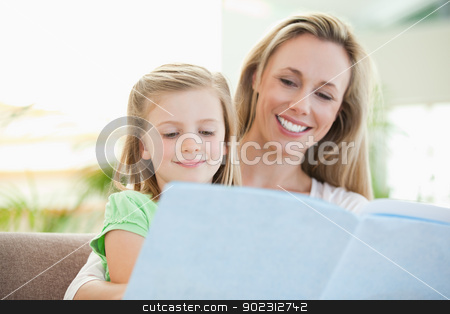 To use this stock image in your creative project, please select the size you need over to the right and click the "Add to Cart" button.
Your downloaded image will come with the Cutcaster watermark removed so don’t worry about the watermark you see on this page. Mother and daughter reading a magazine on the couch stock photo, Mother and daughter reading a magazine together on the couch by Wavebreak Media