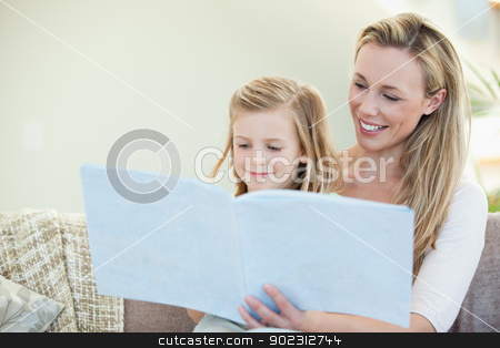 To use this stock image in your creative project, please select the size you need over to the right and click the "Add to Cart" button.
Your downloaded image will come with the Cutcaster watermark removed so don’t worry about the watermark you see on this page. Mother and daughter reading on the couch stock photo, Mother and daughter reading together on the couch by Wavebreak Media