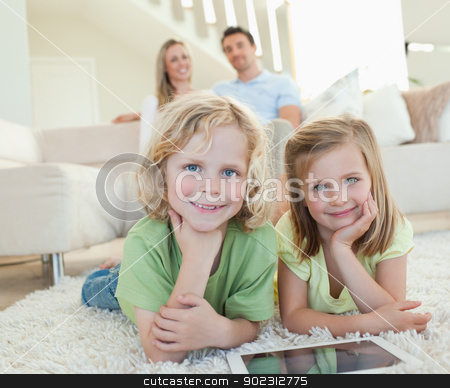 To use this stock image in your creative project, please select the size you need over to the right and click the "Add to Cart" button.
Your downloaded image will come with the Cutcaster watermark removed so don’t worry about the watermark you see on this page. Children on the carpet with tablet and parents behind them stock photo, Children on the carpet together with tablet and parents behind them by Wavebreak Media