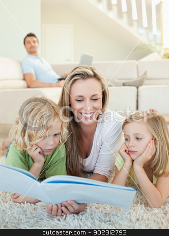 To use this stock image in your creative project, please select the size you need over to the right and click the "Add to Cart" button.
Your downloaded image will come with the Cutcaster watermark removed so don’t worry about the watermark you see on this page. Mother reading magazine with her children on the floor stock photo, Mother reading magazine together with her children on the floor by Wavebreak Media