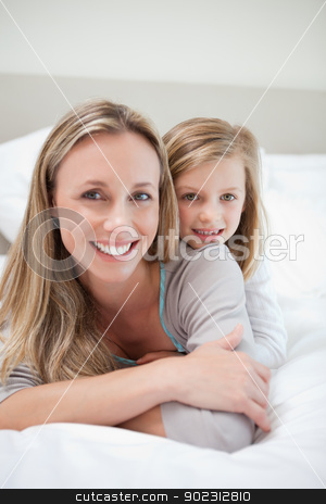 To use this stock image in your creative project, please select the size you need over to the right and click the "Add to Cart" button.
Your downloaded image will come with the Cutcaster watermark removed so don’t worry about the watermark you see on this page. Girl laying on her mothers back stock photo, Little girl laying on her mothers back by Wavebreak Media
