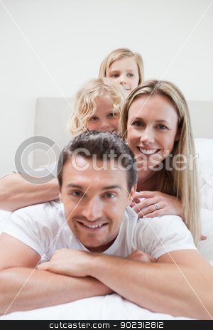 To use this stock image in your creative project, please select the size you need over to the right and click the "Add to Cart" button.
Your downloaded image will come with the Cutcaster watermark removed so don’t worry about the watermark you see on this page. Playful family on the bed stock photo, Playful family together on the bed by Wavebreak Media