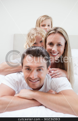 To use this stock image in your creative project, please select the size you need over to the right and click the "Add to Cart" button.
Your downloaded image will come with the Cutcaster watermark removed so don’t worry about the watermark you see on this page. Family enjoying time on the bed stock photo, Family enjoying time together on the bed by Wavebreak Media