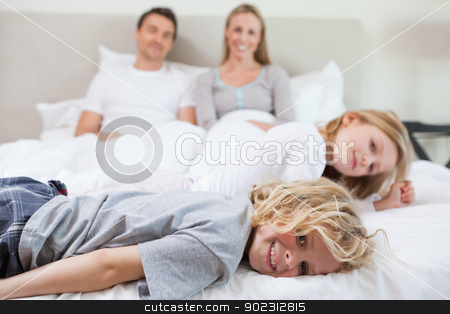 To use this stock image in your creative project, please select the size you need over to the right and click the "Add to Cart" button.
Your downloaded image will come with the Cutcaster watermark removed so don’t worry about the watermark you see on this page. Family relaxing on the bed stock photo, Family relaxing together on the bed by Wavebreak Media