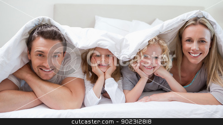 To use this stock image in your creative project, please select the size you need over to the right and click the "Add to Cart" button.
Your downloaded image will come with the Cutcaster watermark removed so don’t worry about the watermark you see on this page. Family under the cover stock photo, Family under the cover together by Wavebreak Media