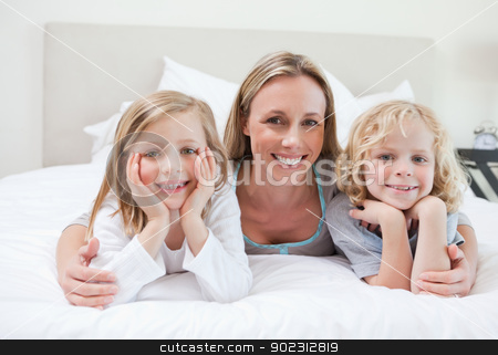 To use this stock image in your creative project, please select the size you need over to the right and click the "Add to Cart" button.
Your downloaded image will come with the Cutcaster watermark removed so don’t worry about the watermark you see on this page. Mother embracing her children stock photo, Mother embracing her children on the bed by Wavebreak Media