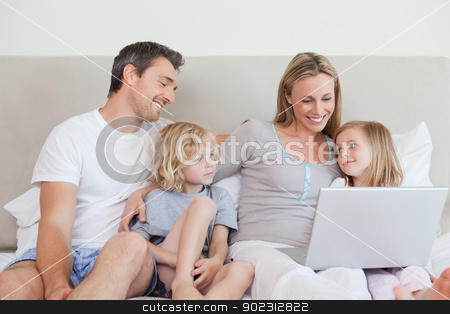 To use this stock image in your creative project, please select the size you need over to the right and click the "Add to Cart" button.
Your downloaded image will come with the Cutcaster watermark removed so don’t worry about the watermark you see on this page. Family using laptop on the bed stock photo, Family using laptop together on the bed by Wavebreak Media