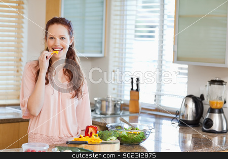 To use this stock image in your creative project, please select the size you need over to the right and click the "Add to Cart" button.
Your downloaded image will come with the Cutcaster watermark removed so don’t worry about the watermark you see on this page. Woman nibbling bell pepper while preparing salad stock photo, Woman nibbling yellow bell pepper while preparing salad by Wavebreak Media