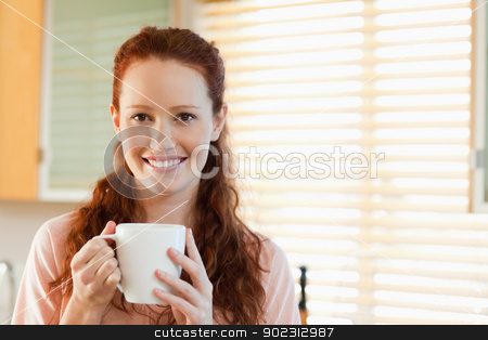 To use this stock image in your creative project, please select the size you need over to the right and click the "Add to Cart" button.
Your downloaded image will come with the Cutcaster watermark removed so don’t worry about the watermark you see on this page. Smiling woman with cup stock photo, Smiling woman with cup in her hands by Wavebreak Media