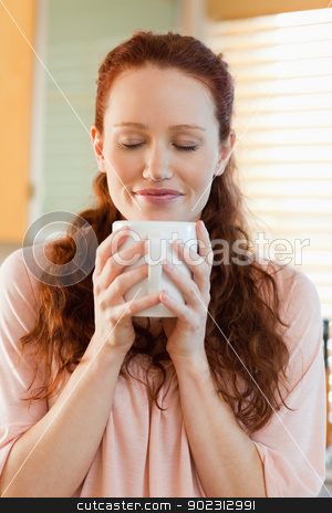 To use this stock image in your creative project, please select the size you need over to the right and click the "Add to Cart" button.
Your downloaded image will come with the Cutcaster watermark removed so don’t worry about the watermark you see on this page. Joyful woman holding a cup of coffee stock photo, Joyful woman holding a cup of hot coffee by Wavebreak Media