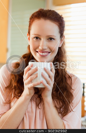To use this stock image in your creative project, please select the size you need over to the right and click the "Add to Cart" button.
Your downloaded image will come with the Cutcaster watermark removed so don’t worry about the watermark you see on this page. Smiling woman with her cup of coffee stock photo, Smiling young woman with her cup of coffee by Wavebreak Media