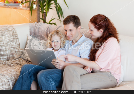 To use this stock image in your creative project, please select the size you need over to the right and click the "Add to Cart" button.
Your downloaded image will come with the Cutcaster watermark removed so don’t worry about the watermark you see on this page. Family using laptop on the sofa stock photo, Young family using laptop on the sofa by Wavebreak Media