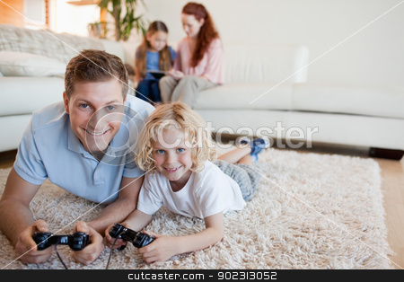 To use this stock image in your creative project, please select the size you need over to the right and click the "Add to Cart" button.
Your downloaded image will come with the Cutcaster watermark removed so don’t worry about the watermark you see on this page. Father and son on the floor playing video games stock photo, Father and son on the floor playing video games together by Wavebreak Media