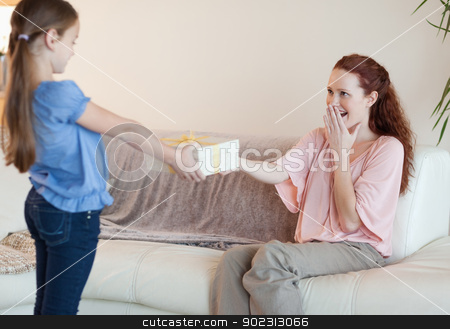 To use this stock image in your creative project, please select the size you need over to the right and click the "Add to Cart" button.
Your downloaded image will come with the Cutcaster watermark removed so don’t worry about the watermark you see on this page. Daughter surprises her mother with a gift stock photo, Young daughter surprises her mother with a gift by Wavebreak Media