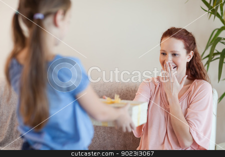 To use this stock image in your creative project, please select the size you need over to the right and click the "Add to Cart" button.
Your downloaded image will come with the Cutcaster watermark removed so don’t worry about the watermark you see on this page. Mother being surprised by daughter with present stock photo, Mother being surprised by her daughter with present by Wavebreak Media