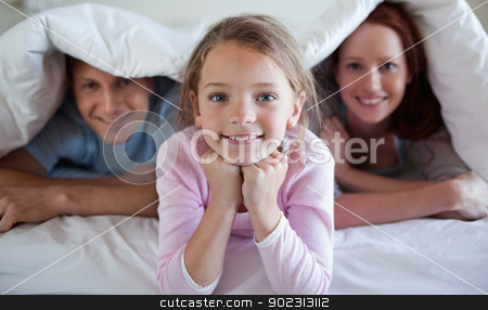 To use this stock image in your creative project, please select the size you need over to the right and click the "Add to Cart" button.
Your downloaded image will come with the Cutcaster watermark removed so don’t worry about the watermark you see on this page. Girl under bed cover with parents stock photo, Girl under bed cover with her parents by Wavebreak Media