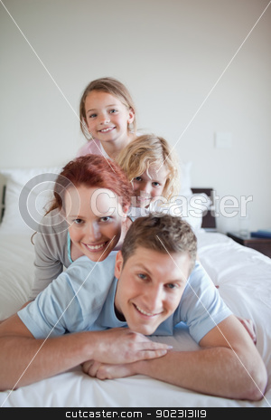 To use this stock image in your creative project, please select the size you need over to the right and click the "Add to Cart" button.
Your downloaded image will come with the Cutcaster watermark removed so don’t worry about the watermark you see on this page. Playful family lying on each other stock photo, Playful family lying on each other on the bed by Wavebreak Media