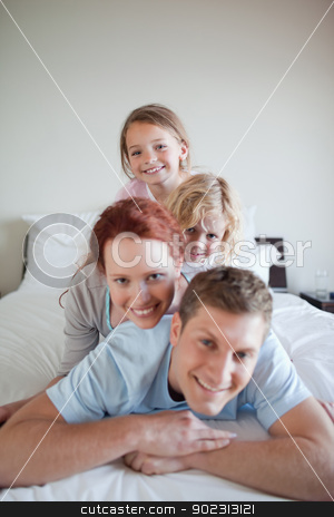 To use this stock image in your creative project, please select the size you need over to the right and click the "Add to Cart" button.
Your downloaded image will come with the Cutcaster watermark removed so don’t worry about the watermark you see on this page. Cheerful family lying on each other stock photo, Cheerful family lying on each other on the bed by Wavebreak Media