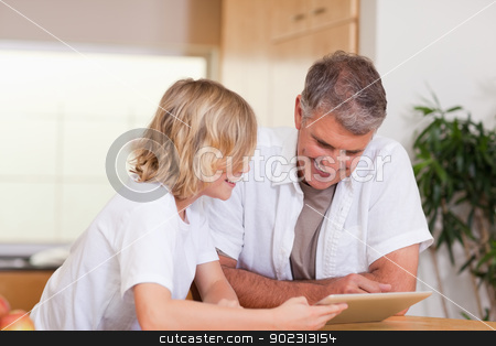 To use this stock image in your creative project, please select the size you need over to the right and click the "Add to Cart" button.
Your downloaded image will come with the Cutcaster watermark removed so don’t worry about the watermark you see on this page. Father and son using tablet stock photo, Father and son using tablet together by Wavebreak Media