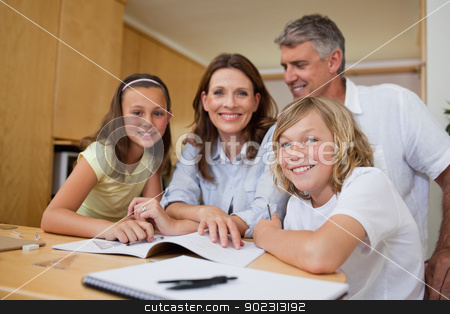 To use this stock image in your creative project, please select the size you need over to the right and click the "Add to Cart" button.
Your downloaded image will come with the Cutcaster watermark removed so don’t worry about the watermark you see on this page. Parents helping children with homework stock photo, Parents helping their children with homework by Wavebreak Media