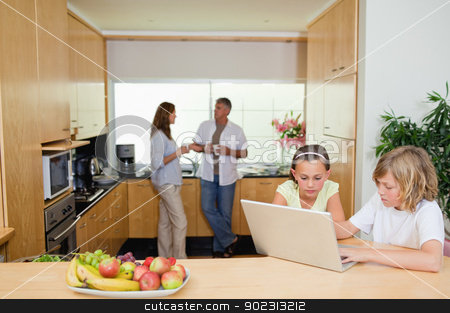 To use this stock image in your creative project, please select the size you need over to the right and click the "Add to Cart" button.
Your downloaded image will come with the Cutcaster watermark removed so don’t worry about the watermark you see on this page. Children with laptop in the kitchen and parents behind them stock photo, Children with their laptop in the kitchen and parents behind them by Wavebreak Media