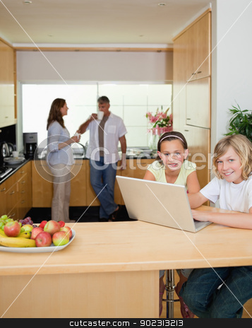 To use this stock image in your creative project, please select the size you need over to the right and click the "Add to Cart" button.
Your downloaded image will come with the Cutcaster watermark removed so don’t worry about the watermark you see on this page. Siblings with laptop in the kitchen with parents behind them stock photo, Siblings with their laptop in the kitchen with parents behind them by Wavebreak Media