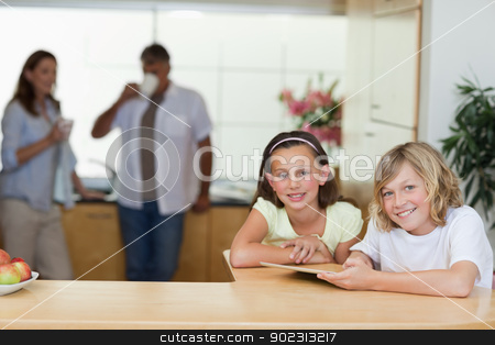 To use this stock image in your creative project, please select the size you need over to the right and click the "Add to Cart" button.
Your downloaded image will come with the Cutcaster watermark removed so don’t worry about the watermark you see on this page. Siblings using tablet in the kitchen with parents behind them stock photo, Siblings using tablet in the kitchen with their parents behind them by Wavebreak Media