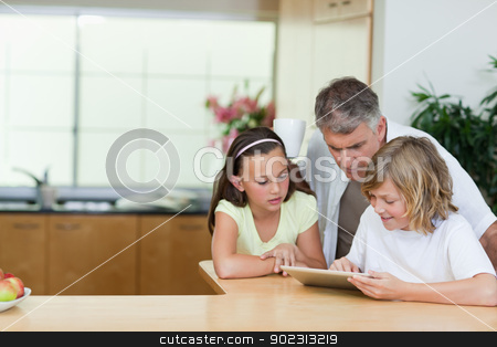 To use this stock image in your creative project, please select the size you need over to the right and click the "Add to Cart" button.
Your downloaded image will come with the Cutcaster watermark removed so don’t worry about the watermark you see on this page. Man looking at tablet his children are using stock photo, Man looking at the tablet his children are using by Wavebreak Media