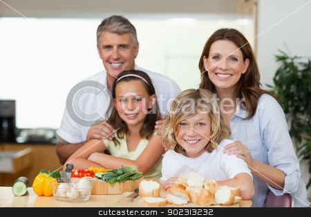 To use this stock image in your creative project, please select the size you need over to the right and click the "Add to Cart" button.
Your downloaded image will come with the Cutcaster watermark removed so don’t worry about the watermark you see on this page. Smiling family making sandwiches stock photo, Smiling family making sandwiches together by Wavebreak Media