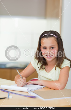 To use this stock image in your creative project, please select the size you need over to the right and click the "Add to Cart" button.
Your downloaded image will come with the Cutcaster watermark removed so don’t worry about the watermark you see on this page. Smiling girl doing homework stock photo, Smiling girl doing her homework by Wavebreak Media