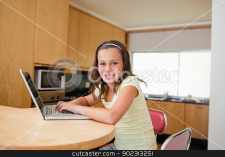To use this stock image in your creative project, please select the size you need over to the right and click the "Add to Cart" button.
Your downloaded image will come with the Cutcaster watermark removed so don’t worry about the watermark you see on this page. Girl with laptop at the kitchen table stock photo, Girl with laptop sitting at the kitchen table by Wavebreak Media