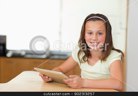 To use this stock image in your creative project, please select the size you need over to the right and click the "Add to Cart" button.
Your downloaded image will come with the Cutcaster watermark removed so don’t worry about the watermark you see on this page. Smiling girl with tablet at kitchen table stock photo, Smiling girl with tablet at the kitchen table by Wavebreak Media