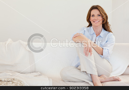 To use this stock image in your creative project, please select the size you need over to the right and click the "Add to Cart" button.
Your downloaded image will come with the Cutcaster watermark removed so don’t worry about the watermark you see on this page. Smiling mature woman sitting on sofa stock photo, Smiling mature woman sitting on her sofa by Wavebreak Media