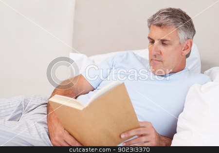 To use this stock image in your creative project, please select the size you need over to the right and click the "Add to Cart" button.
Your downloaded image will come with the Cutcaster watermark removed so don’t worry about the watermark you see on this page. Mature man reading book in bed stock photo, Mature man reading book in the bed by Wavebreak Media