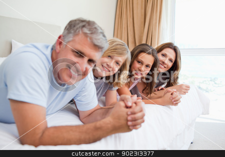 To use this stock image in your creative project, please select the size you need over to the right and click the "Add to Cart" button.
Your downloaded image will come with the Cutcaster watermark removed so don’t worry about the watermark you see on this page. Happy family lying on the bed stock photo, Happy family lying on the bed together by Wavebreak Media
