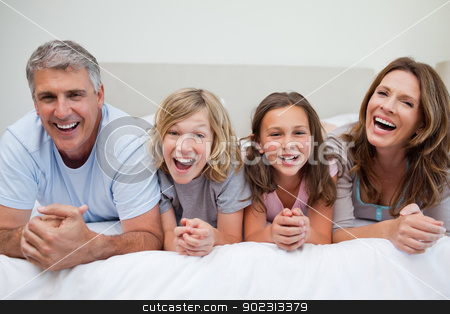 To use this stock image in your creative project, please select the size you need over to the right and click the "Add to Cart" button.
Your downloaded image will come with the Cutcaster watermark removed so don’t worry about the watermark you see on this page. Laughing family lying on the bed stock photo, Laughing family lying on the bed together by Wavebreak Media