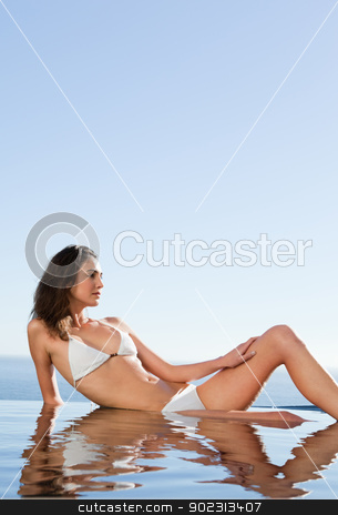 To use this stock image in your creative project, please select the size you need over to the right and click the "Add to Cart" button.
Your downloaded image will come with the Cutcaster watermark removed so don’t worry about the watermark you see on this page. Woman enjoying the sun on pool edge stock photo, Woman enjoying the sun on the pool edge by Wavebreak Media