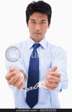 To use this stock image in your creative project, please select the size you need over to the right and click the "Add to Cart" button.
Your downloaded image will come with the Cutcaster watermark removed so don’t worry about the watermark you see on this page. Portrait of a businessman with handcuffs stock photo, Portrait of a businessman with handcuffs against a white background by Wavebreak Media