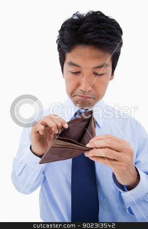 To use this stock image in your creative project, please select the size you need over to the right and click the "Add to Cart" button.
Your downloaded image will come with the Cutcaster watermark removed so don’t worry about the watermark you see on this page. Portrait of a sad businessman showing his empty wallet stock photo, Portrait of a sad businessman showing his empty wallet against a white background by Wavebreak Media