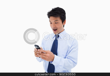 To use this stock image in your creative project, please select the size you need over to the right and click the "Add to Cart" button.
Your downloaded image will come with the Cutcaster watermark removed so don’t worry about the watermark you see on this page. Surprised business man reading a text message stock photo, Surprised business man reading a text message against a white background by Wavebreak Media