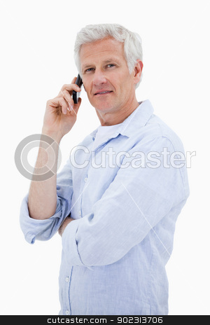 To use this stock image in your creative project, please select the size you need over to the right and click the "Add to Cart" button.
Your downloaded image will come with the Cutcaster watermark removed so don’t worry about the watermark you see on this page. Portrait of a mature man making a phone call while looking at th stock photo, Portrait of a mature man making a phone call while looking at the camera against a white background by Wavebreak Media