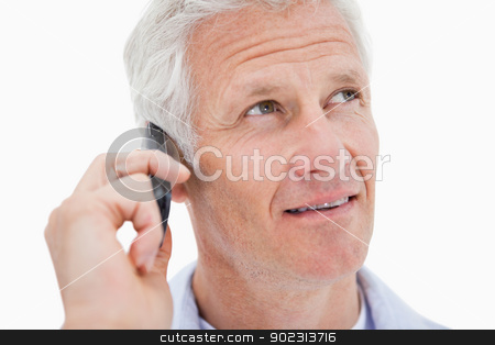 To use this stock image in your creative project, please select the size you need over to the right and click the "Add to Cart" button.
Your downloaded image will come with the Cutcaster watermark removed so don’t worry about the watermark you see on this page. Mature man making a phone call while looking up stock photo, Mature man making a phone call while looking up against a white background by Wavebreak Media