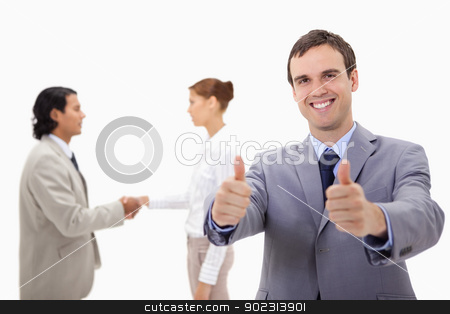 To use this stock image in your creative project, please select the size you need over to the right and click the "Add to Cart" button.
Your downloaded image will come with the Cutcaster watermark removed so don’t worry about the watermark you see on this page. Businessman approving with hand shaking colleagues behind him stock photo, Businessman approving with hand shaking colleagues behind him against a white background by Wavebreak Media