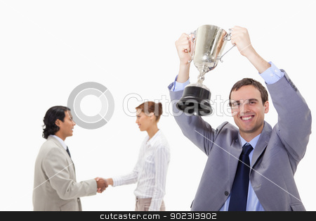To use this stock image in your creative project, please select the size you need over to the right and click the "Add to Cart" button.
Your downloaded image will come with the Cutcaster watermark removed so don’t worry about the watermark you see on this page. Businessman raising cup with hand shaking colleagues behind him stock photo, Businessman raising cup with hand shaking colleagues behind him against a white background by Wavebreak Media