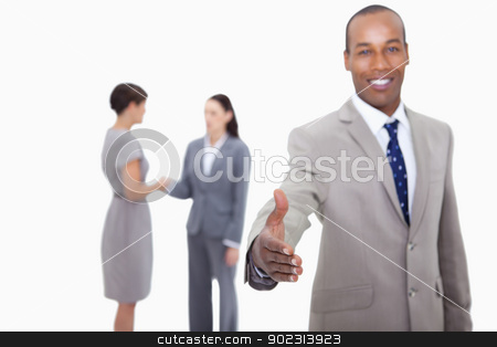 To use this stock image in your creative project, please select the size you need over to the right and click the "Add to Cart" button.
Your downloaded image will come with the Cutcaster watermark removed so don’t worry about the watermark you see on this page. Smiling businessman offering his hand with hand shaking colleagu stock photo, Smiling businessman offering his hand with hand shaking colleagues behind him against a white background by Wavebreak Media