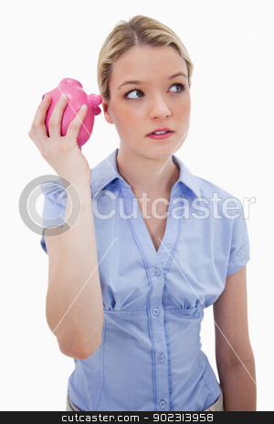 To use this stock image in your creative project, please select the size you need over to the right and click the "Add to Cart" button.
Your downloaded image will come with the Cutcaster watermark removed so don’t worry about the watermark you see on this page. Curious woman shaking piggy bank stock photo, Curious woman shaking piggy bank against a white background by Wavebreak Media
