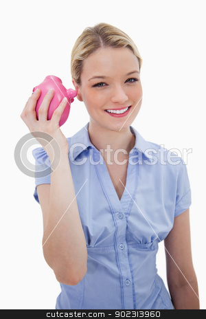 To use this stock image in your creative project, please select the size you need over to the right and click the "Add to Cart" button.
Your downloaded image will come with the Cutcaster watermark removed so don’t worry about the watermark you see on this page. Smiling woman shaking her piggy bank stock photo, Smiling woman shaking her piggy bank against a white background by Wavebreak Media