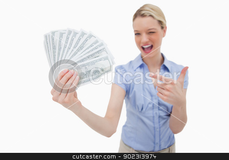 To use this stock image in your creative project, please select the size you need over to the right and click the "Add to Cart" button.
Your downloaded image will come with the Cutcaster watermark removed so don’t worry about the watermark you see on this page. Woman holding money and pointing at it stock photo, Woman holding money and pointing at it against a white background by Wavebreak Media
