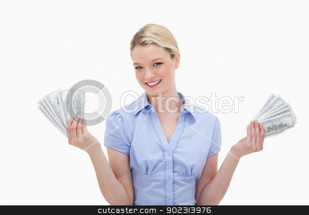 To use this stock image in your creative project, please select the size you need over to the right and click the "Add to Cart" button.
Your downloaded image will come with the Cutcaster watermark removed so don’t worry about the watermark you see on this page. Smiling woman holding money in her hands stock photo, Smiling woman holding money in her hands against a white background by Wavebreak Media